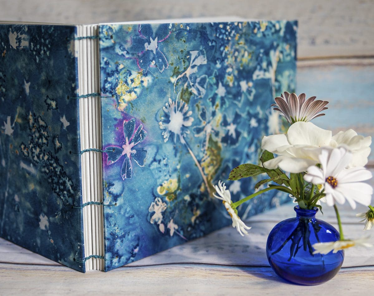 The covers for this landscape A4 hand bound book were made using original cyanotype prints. The front cover is a wet cyanotype, created using so many wildflowers gathered from the hedgerows around my beautiful Wiltshire home … there are Wild Mallows, Oxeye Daises, Buttercups and Toadflax. The back cover mainly features Wild Mallow flowers.