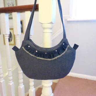 Denim tote with a frill and stud detail.