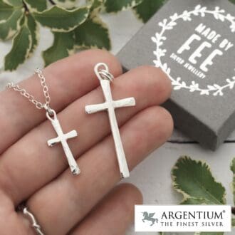 Hammered Argentium silver crosses, one small one larger shown on hand