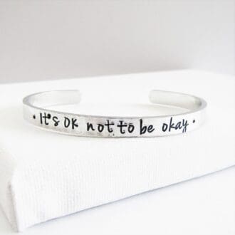 6mm wide aluminium cuff bracelet hand-stamped with 'It's OK not to be okay'