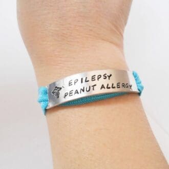 personalised hand stamped medical ID aluminium bar with an elastic stretchy bracelet