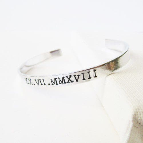 6mm aluminium cuff hand-stamped with a personalised date in roman numerals