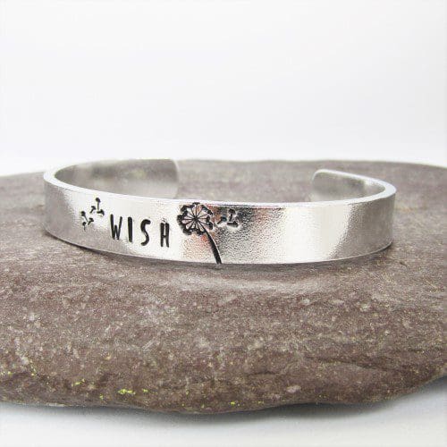 9mm wide aluminium cuff bracelet with the word 'wish' hand-stamped alongside a dandelion image with seeds