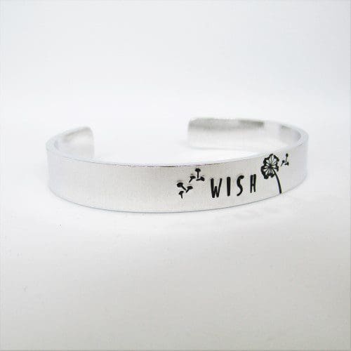 9mm wide aluminium cuff bracelet with the word 'wish' hand-stamped alongside a dandelion image with seeds