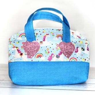 Toy handbag in blue featuring unicorns