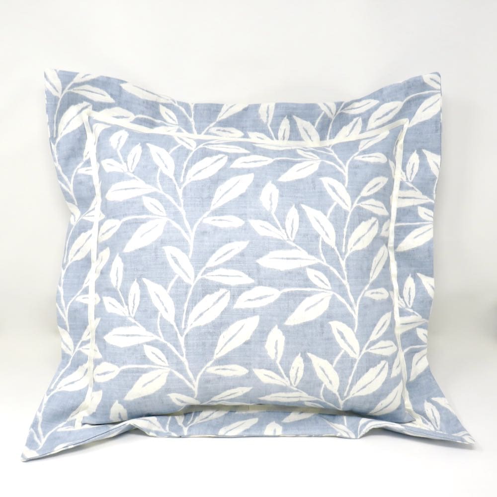 A flanged cushion in a classic blue and white leaf print.