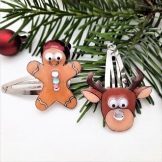 Cute hair clips of googly eyed gingerbread man and shiny nosed reindeer.