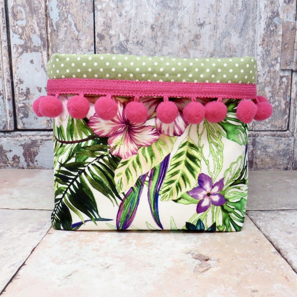 Floral velvet storage bin with a pom pom trim
