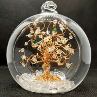 Gold wire tree sitting inside an 8cm glass open fronted bauble. The tree is decorated with clear crystals and birthstones with a crystal heart wired near the roots.