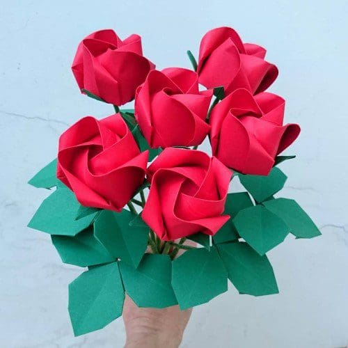 bouquet of red origami roses with green leaves