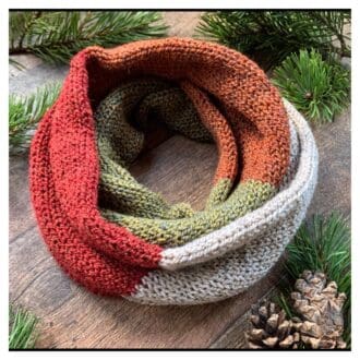 Knitted infinity scarf with colour block stripes in woodland shades