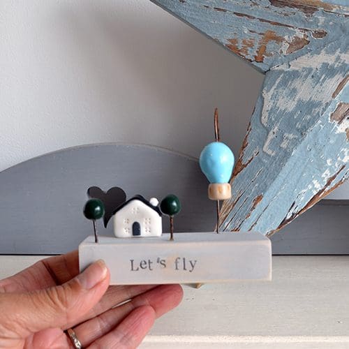 Handmade wood and clay motivational gift with house and hot air balloon.