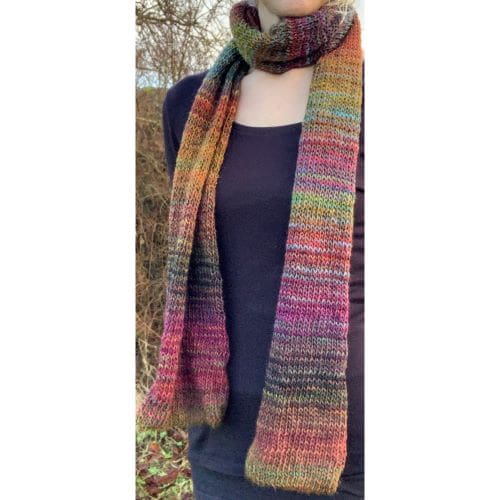 Long lightweight jewel tone scarf, looping once around the neck and falling to the waist