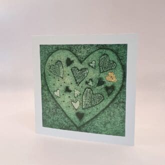 Love is, green heart greetings card
