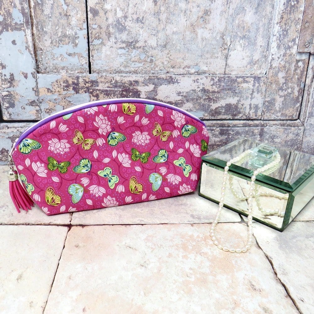 Handmade pink butterfly print makeup bag with tassel trim