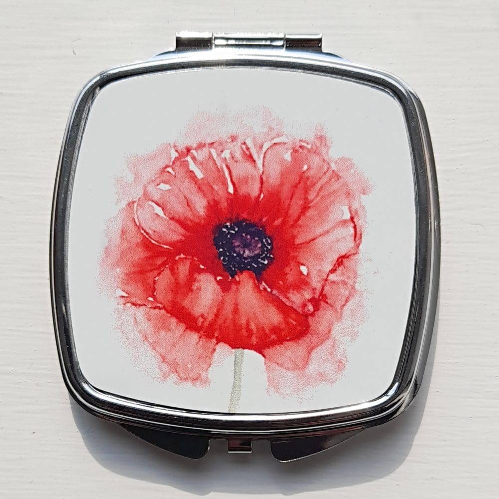 Compact mirror showing poppy artwork