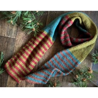 Long knitted scarf in shades of autumn stripes of large colour blocks of plain and stripes vegan