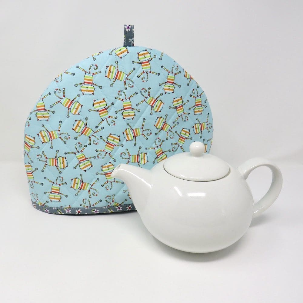 Quilted tea cosy in a stripey cat fabric, handmade by Wild Rose Designs