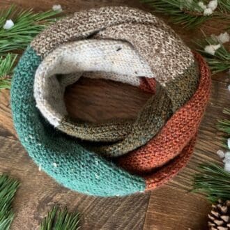 Colour block scarf of textured green and browns yarns