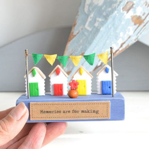 Miniature handmade wood and clay beach hut scene.