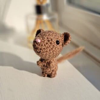 brown dormouse soft sculpture on window sill