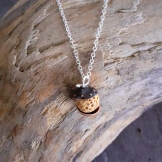 Copper and yellow lava rock bead pendant on a silver chain