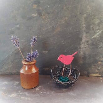 Recycled copper wire birds nest with red bird