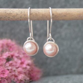 Long silver earrings with pink pearls