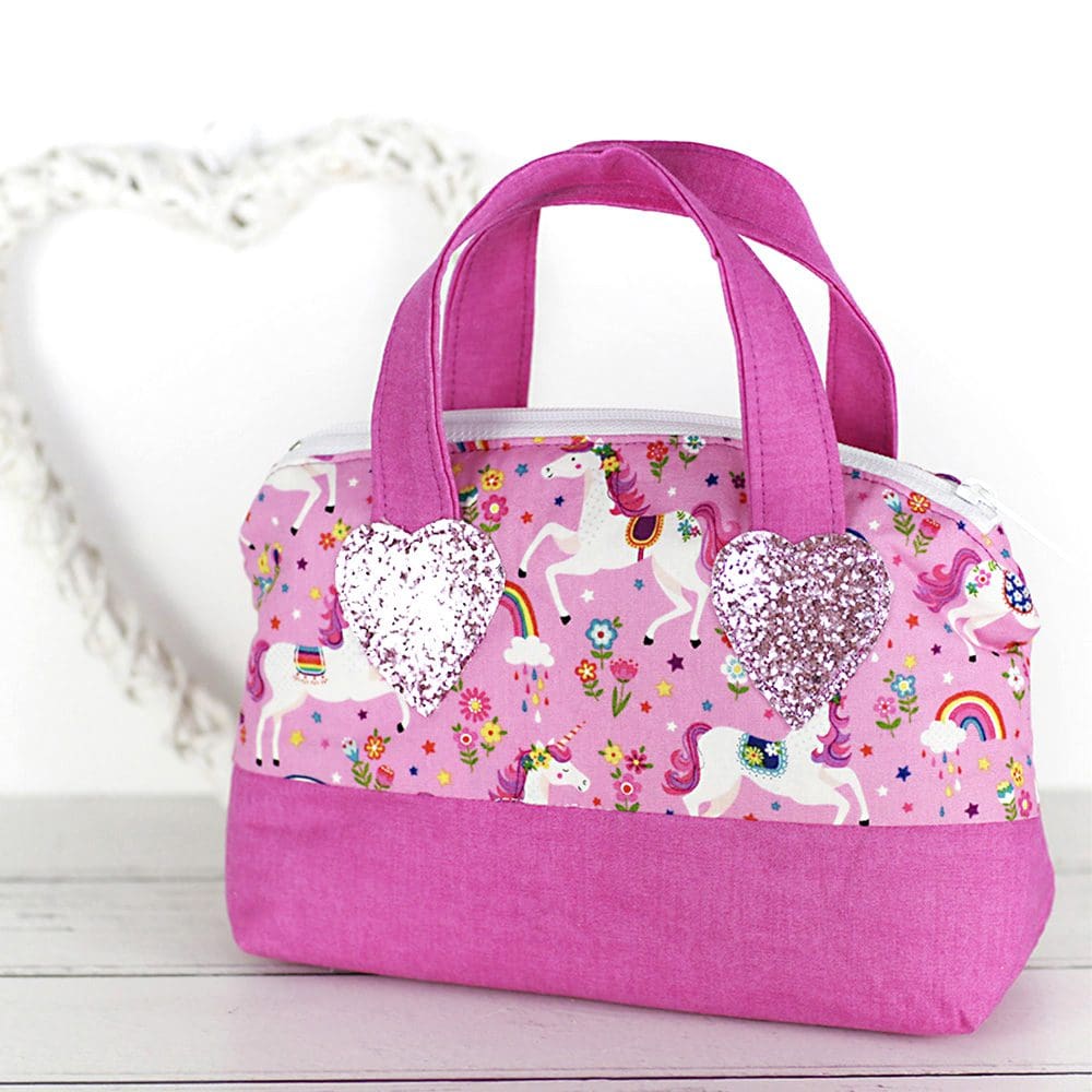 Toy handbag in pink featuring unicorns