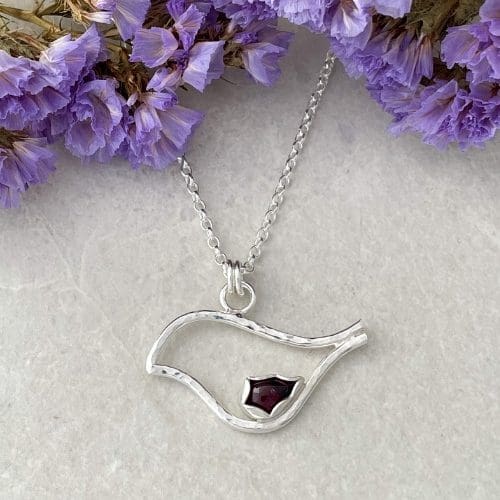 Silver bird robin necklace set with a red garnet gemstone