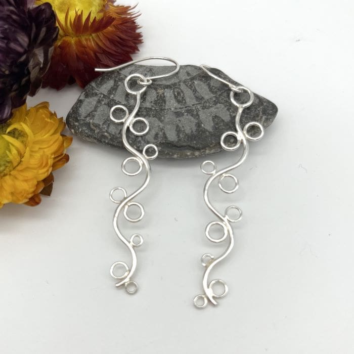 long swirl and circle drop earrings in silver on silver ear wires