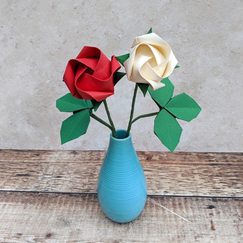 red and white origami roses in vase
