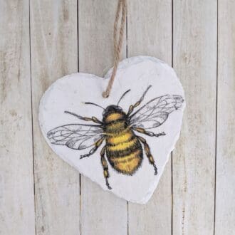 Small slate hanging heart painted white and decouoaged with a single bee, finished with a natural twine hanger