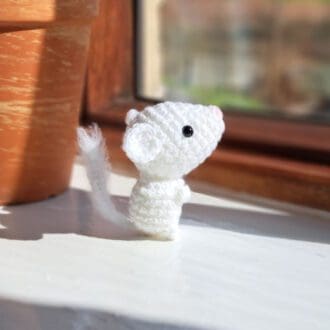 White dormouse soft sculpture on window sill