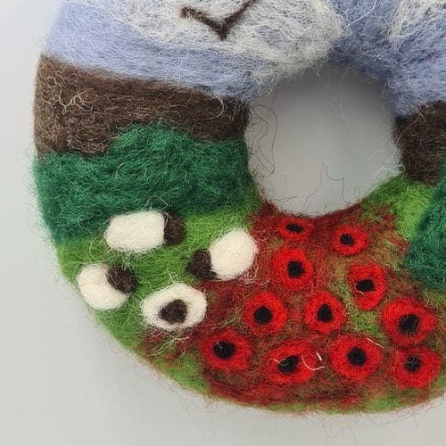 Close up of needle felted poppy wreath
