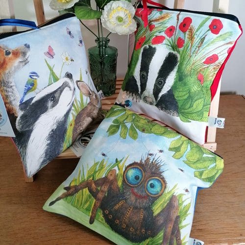 Selection of three designs of medium washbags featuring either a badger, a spider or a group of wildlife of a fox, badger, bird, rabbit and hedgehog. Each has a chunky zipper fastening with a satin ribbon pull, coloured back, water resistant lining and an internal pocket.