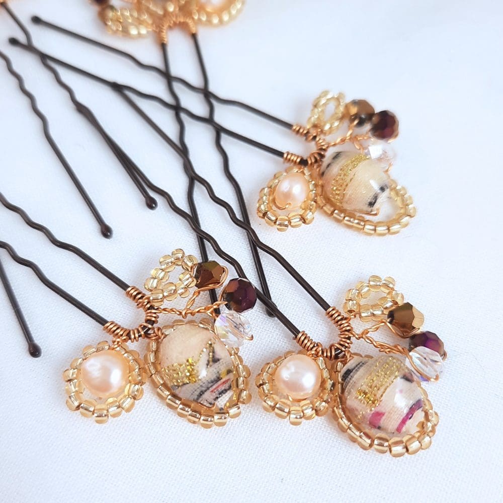 Hair pins in shades of cream with crystal and gold.