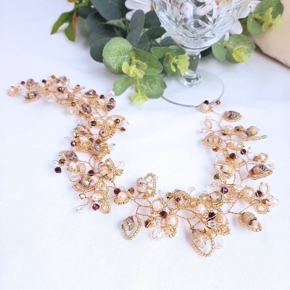 Hair vine in shades of cream with crystal and gold.