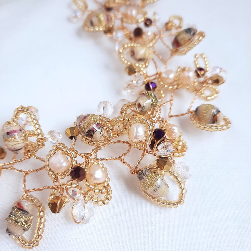 Hair vine in shades of cream with crystal and gold.