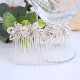 Bridal hair comb with pearl and silver flowers with have crystal centres.