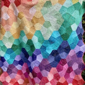Bright, geometric, rainbow patchwork quilt