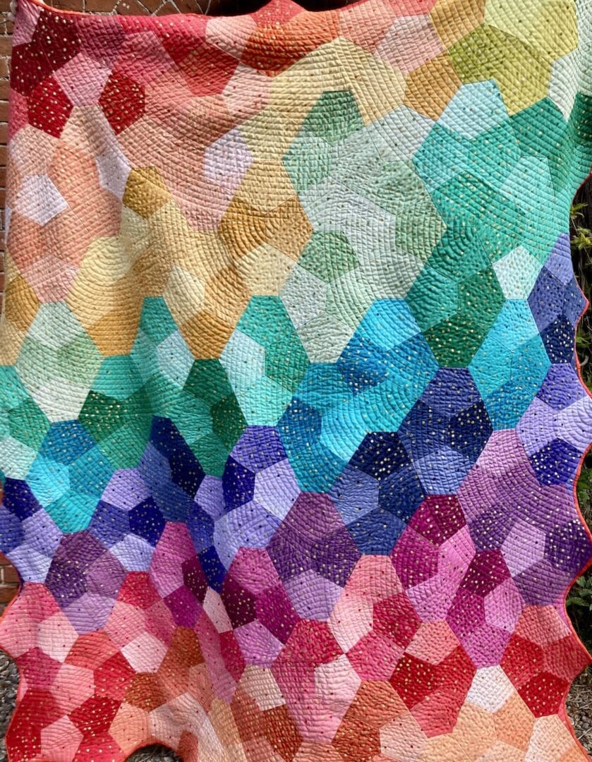 Bright, geometric, rainbow patchwork quilt