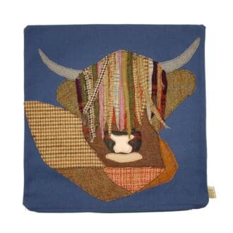 Applique Highland Cow cushion on denim blue cotton cover
