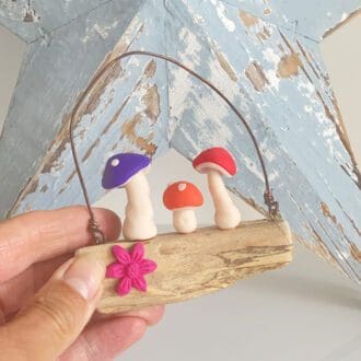 Miniature polymer clay toadstools set on driftwood wall hanger