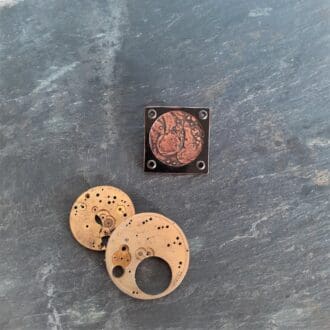 Recycled copper brooch textured with watch parts
