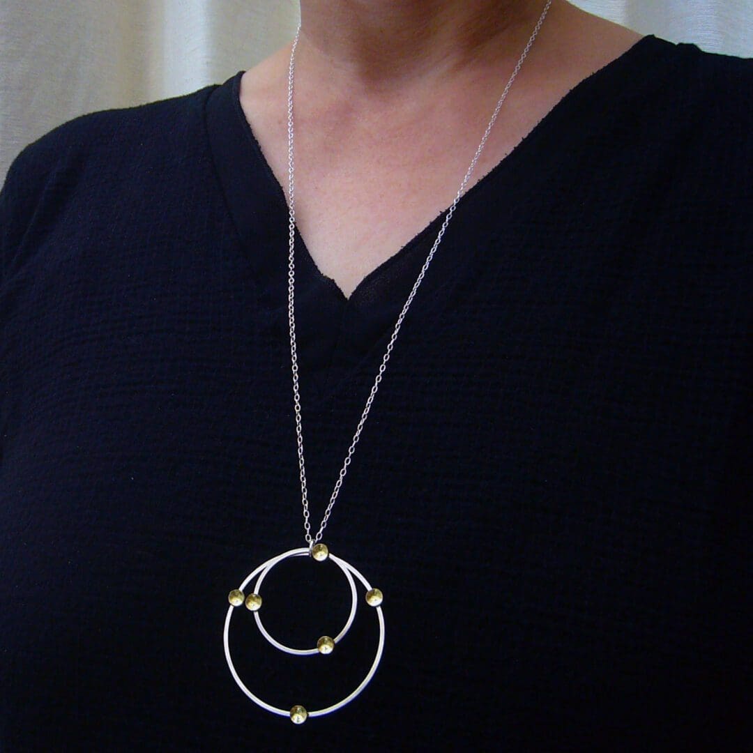 handmade sterling silver wire and brass circles pendant