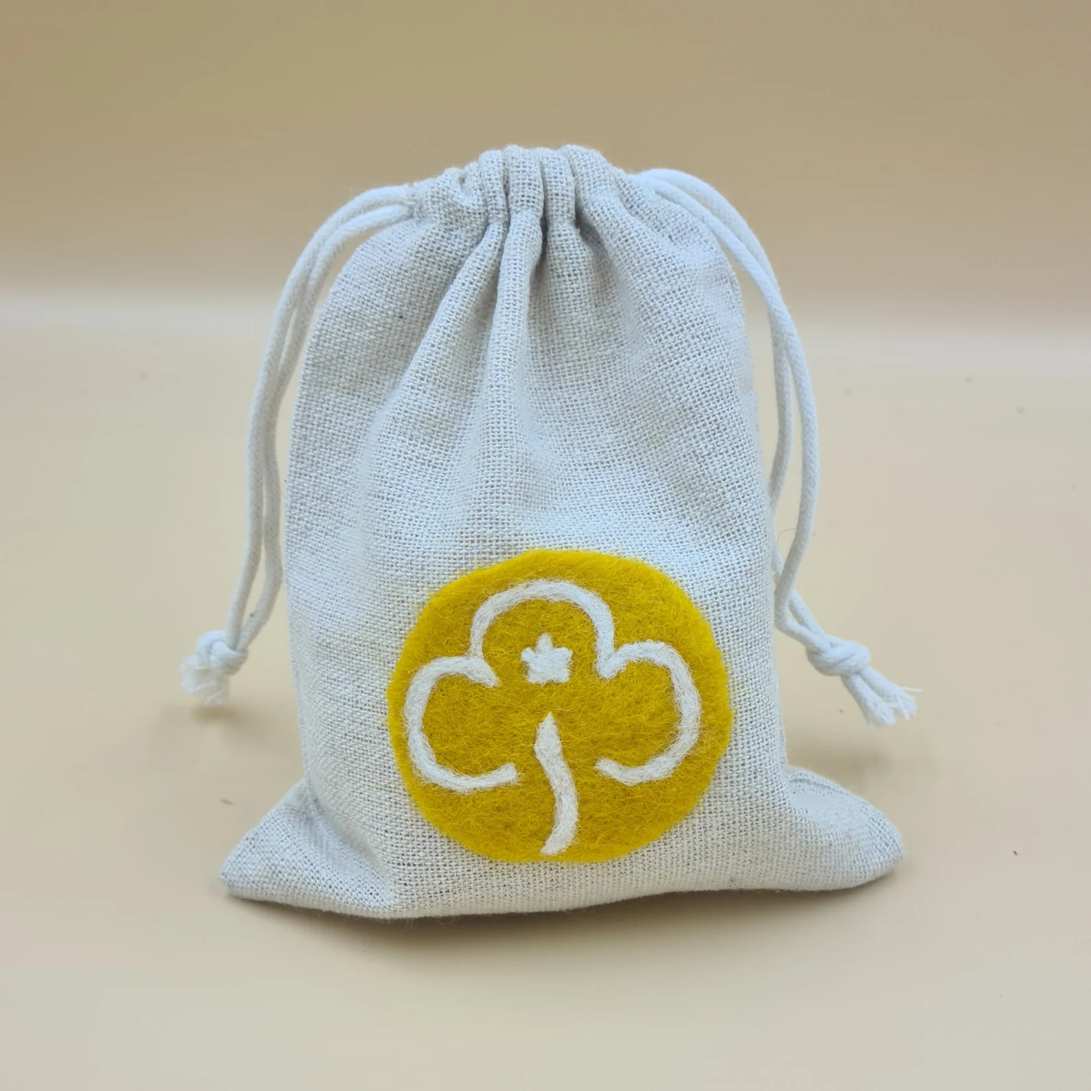 Cotton drawstring bag featuring needle felted Girlguiding Brownies trefoil.
