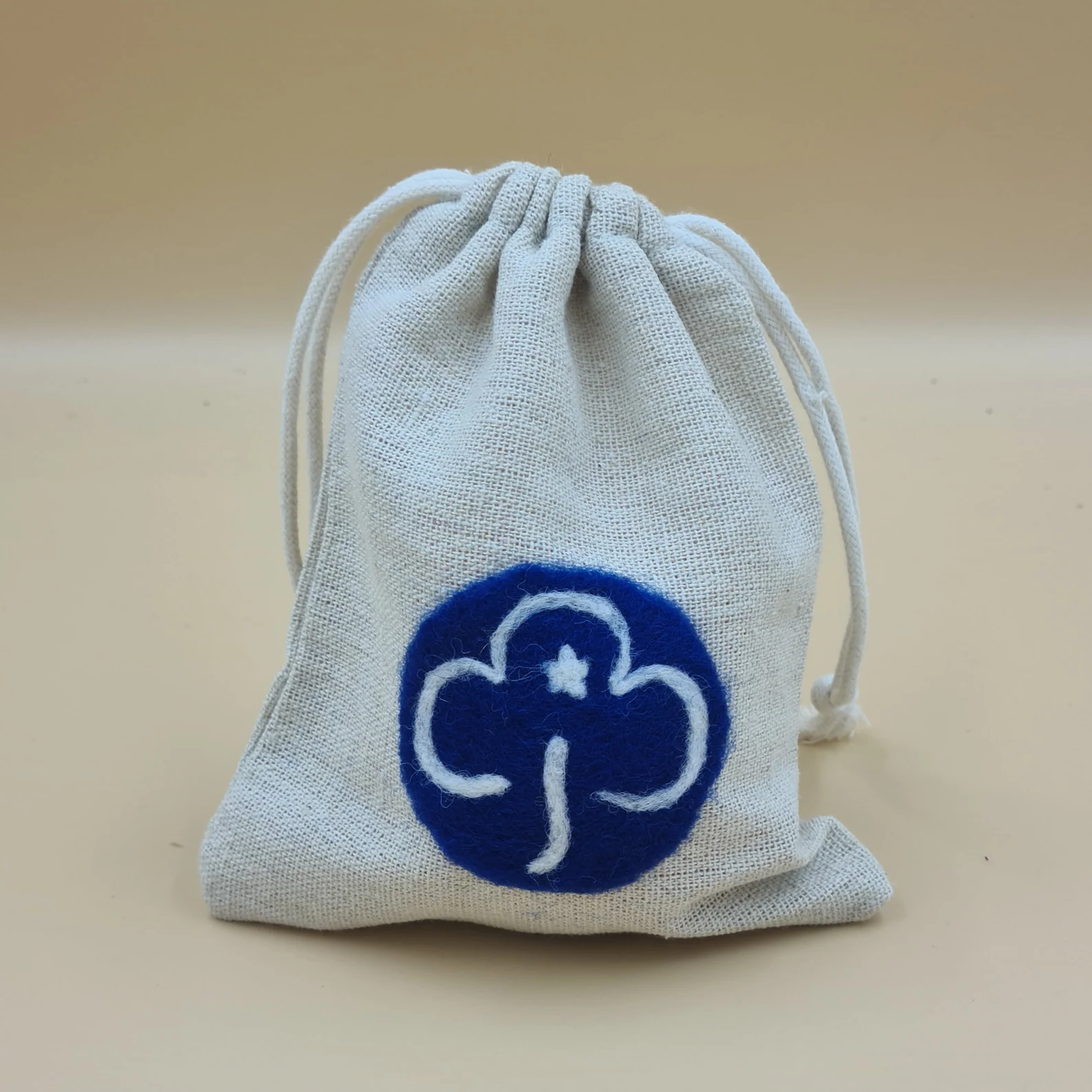 Cotton drawstring bag featuring needle felted Girlguiding Guides trefoil.
