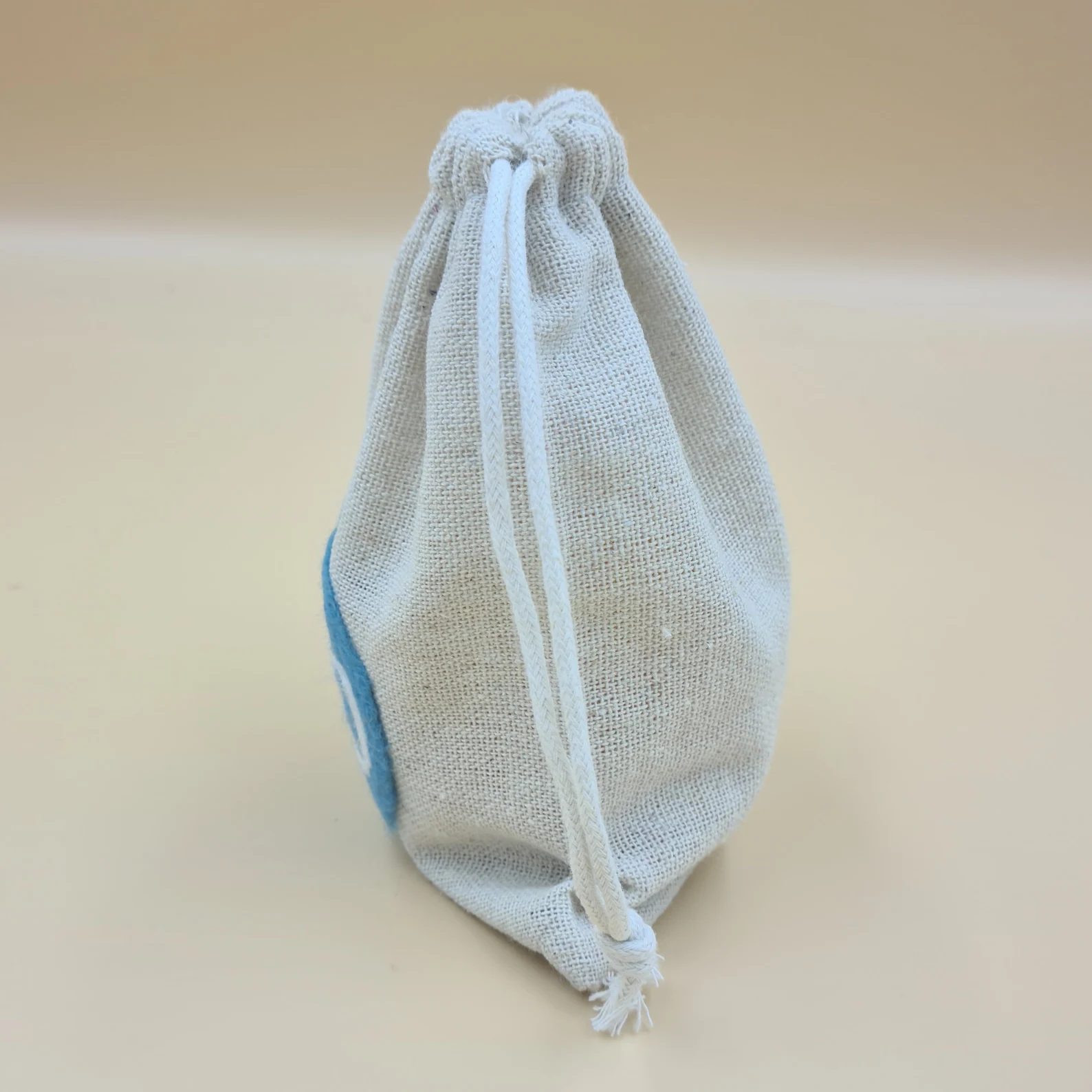 Side view of cotton drawstring bag