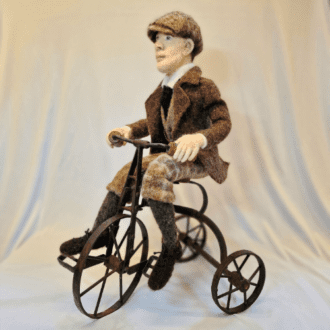 Peaky Biker, needlefelt sculpture on an antique toy tricycle